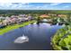 Aerial view of the community showing the lake with fountain and the community pool area at 121 Madiera Beach Blvd, Kissimmee, FL 34746