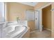 Secondary bathroom featuring large tub, glass shower and tiled floor at 121 Madiera Beach Blvd, Kissimmee, FL 34746