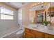 Bright bathroom features a tub with tile surround, a window, and a vanity with ample countertop space at 121 Madiera Beach Blvd, Kissimmee, FL 34746