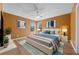 Bright bedroom with fan, windows, and stylish decor at 121 Madiera Beach Blvd, Kissimmee, FL 34746