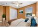 Bright bedroom with a ceiling fan, closet, wood floors, and scenic outdoor views through a window at 121 Madiera Beach Blvd, Kissimmee, FL 34746