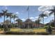 Stately clubhouse entrance with meticulously landscaped grounds, showcasing the community's commitment to luxury and curb appeal at 121 Madiera Beach Blvd, Kissimmee, FL 34746