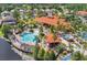 Community clubhouse featuring a large pool, lounge chairs, covered seating and lush landscaping at 121 Madiera Beach Blvd, Kissimmee, FL 34746