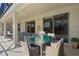 Covered patio with outdoor seating, ideal for al fresco dining and entertaining guests at 121 Madiera Beach Blvd, Kissimmee, FL 34746