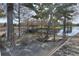 Relaxing lakeside hammock area featuring a wooden bridge, lush greenery, and tranquil views at 121 Madiera Beach Blvd, Kissimmee, FL 34746