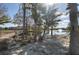 Relaxing hammock area by the lake with a wooden bridge, fountain, and lush trees at 121 Madiera Beach Blvd, Kissimmee, FL 34746