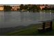 A serene view of the lake at dusk with a bench to sit and enjoy the scenery at 121 Madiera Beach Blvd, Kissimmee, FL 34746