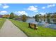 A serene lake view with walking path and bench at 121 Madiera Beach Blvd, Kissimmee, FL 34746
