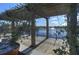 Lakeside pergola with a view of the water and fountain, lush landscaping, and clear skies at 121 Madiera Beach Blvd, Kissimmee, FL 34746