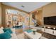 Bright living room with modern decor, adjacent dining area, and open staircase at 121 Madiera Beach Blvd, Kissimmee, FL 34746