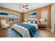 Comfortable main bedroom features a ceiling fan, large windows, and ensuite bathroom access at 121 Madiera Beach Blvd, Kissimmee, FL 34746