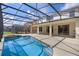 Inviting pool with a patio area, screened enclosure, and open views, perfect for relaxation and entertainment at 121 Madiera Beach Blvd, Kissimmee, FL 34746