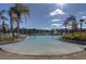 Stunning community pool with plenty of lounge chairs surrounded by mature palm trees at 121 Madiera Beach Blvd, Kissimmee, FL 34746