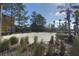 Community sand volleyball court with net, lush greenery, and nearby buildings at 121 Madiera Beach Blvd, Kissimmee, FL 34746