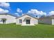 A well-maintained backyard with a patio, lush green grass, and a view of neighboring houses at 1548 Tiverton Blvd, Winter Garden, FL 34787