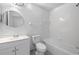 Bathroom featuring a vanity, toilet, and a shower-tub combo with white tile surround at 1548 Tiverton Blvd, Winter Garden, FL 34787
