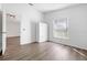 Cozy bedroom with light wood floor, white trim, a window with a backyard view, and closet at 1548 Tiverton Blvd, Winter Garden, FL 34787