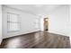 Bright bedroom with wood-look flooring, neutral walls, and ample natural light from two windows at 1548 Tiverton Blvd, Winter Garden, FL 34787