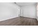 Large bedroom with wood-look floors, and neutral paint. Open doorway leading to another room at 1548 Tiverton Blvd, Winter Garden, FL 34787
