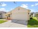 Charming one-story home featuring a two-car garage, landscaped yard, and neutral color palette at 1548 Tiverton Blvd, Winter Garden, FL 34787
