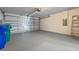 Spacious garage with painted floor, overhead lighting, and a sectional garage door at 1548 Tiverton Blvd, Winter Garden, FL 34787