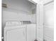 Laundry room with washer, dryer, and wire shelving at 1548 Tiverton Blvd, Winter Garden, FL 34787