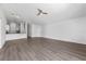 Large living room with wood-look flooring and lots of natural light at 1548 Tiverton Blvd, Winter Garden, FL 34787