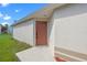 Side entry door of a light colored one-story home at 1548 Tiverton Blvd, Winter Garden, FL 34787