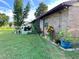 Brick home with a patio, grill, and colorful landscaping at 2867 Longleaf Ct, Kissimmee, FL 34746