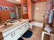 Clean bathroom with double vanity, tub, and updated flooring at 2867 Longleaf Ct, Kissimmee, FL 34746