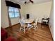 Charming dining area with wood flooring and white table set at 2867 Longleaf Ct, Kissimmee, FL 34746
