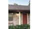 Red front door with white columns and exterior light at 2867 Longleaf Ct, Kissimmee, FL 34746