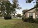 Landscaped front yard with mature trees and shrubs at 2867 Longleaf Ct, Kissimmee, FL 34746