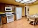 Kitchen features wood cabinets, blue tile, and a breakfast table at 2867 Longleaf Ct, Kissimmee, FL 34746