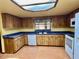 Kitchen with wood cabinets, blue tile, and white appliances at 2867 Longleaf Ct, Kissimmee, FL 34746