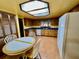Kitchen with wood cabinets, blue tile, and breakfast nook at 2867 Longleaf Ct, Kissimmee, FL 34746