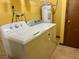 Laundry room with washer, dryer, and water heater at 2867 Longleaf Ct, Kissimmee, FL 34746