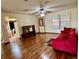 Living room with hardwood floors and red couch near entrance at 2867 Longleaf Ct, Kissimmee, FL 34746