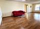 Living room with hardwood floors and red couch at 2867 Longleaf Ct, Kissimmee, FL 34746