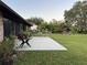 Concrete patio with green table and surrounding plants at 2867 Longleaf Ct, Kissimmee, FL 34746