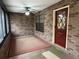 Cozy screened porch with brick walls, ceiling fan, and carpet at 2867 Longleaf Ct, Kissimmee, FL 34746