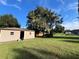 Tan colored storage shed with a large door and window at 2867 Longleaf Ct, Kissimmee, FL 34746