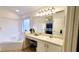 This bathroom has a soaking tub, vanity, large mirror, and neutral walls and tile floors at 1652 Dunes Ct, Haines City, FL 33844