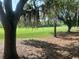 View of the lush green golf course from the backyard of the property at 1652 Dunes Ct, Haines City, FL 33844