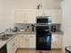 Efficient kitchen with white cabinets and modern appliances at 1652 Dunes Ct, Haines City, FL 33844