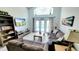 This living room has soaring ceilings, large windows, two sofas, and a view of the pool at 1652 Dunes Ct, Haines City, FL 33844