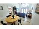 Living area with an oval wooden table, tile floors, and access to a screened patio at 1652 Dunes Ct, Haines City, FL 33844