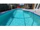 Inviting in-ground pool with screened-in lanai, offering a serene and private outdoor space at 1652 Dunes Ct, Haines City, FL 33844