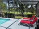 Screened-in pool deck featuring comfortable lounge chairs and peaceful views of the golf course at 1652 Dunes Ct, Haines City, FL 33844