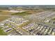An aerial view displays rows of single-Gathering homes in a well-planned community near a highway at 1853 Summer Serenity Dr, Kissimmee, FL 34744